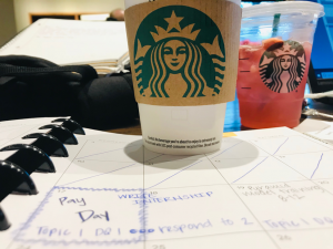 starbucks cup on a notebook studying.